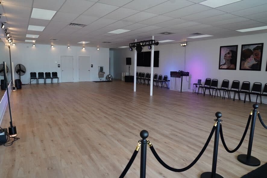 Back of the studio with chairs, fans, and doors to the restrooms