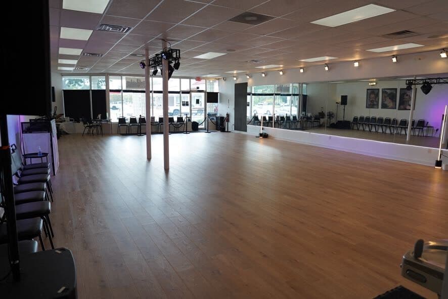 Studio floor from the corner, showing the mirror wall and front windows