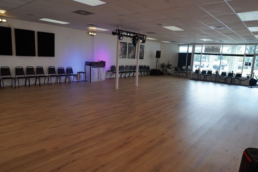 Large open floor with rows of chairs set along the walls